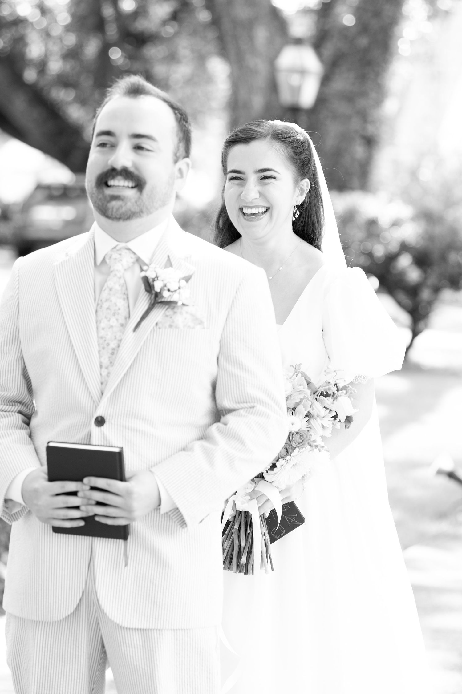 A wedding ceremony in progress with attendants in white attire.