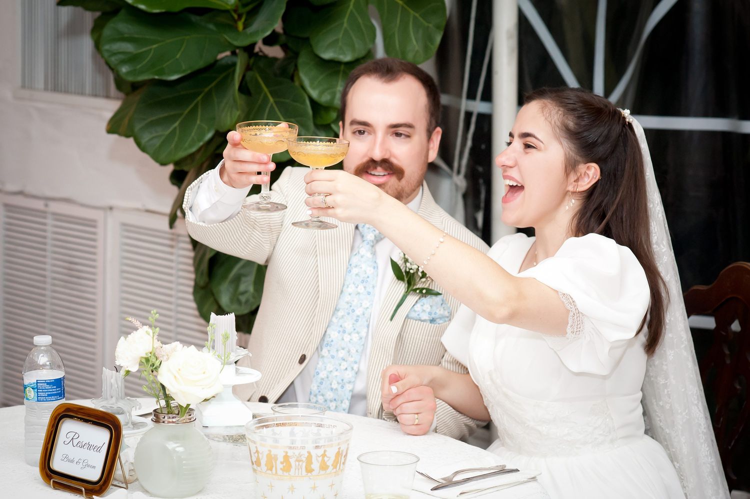 Wedding guests enjoying drinks and conversation at an outdoor celebration.