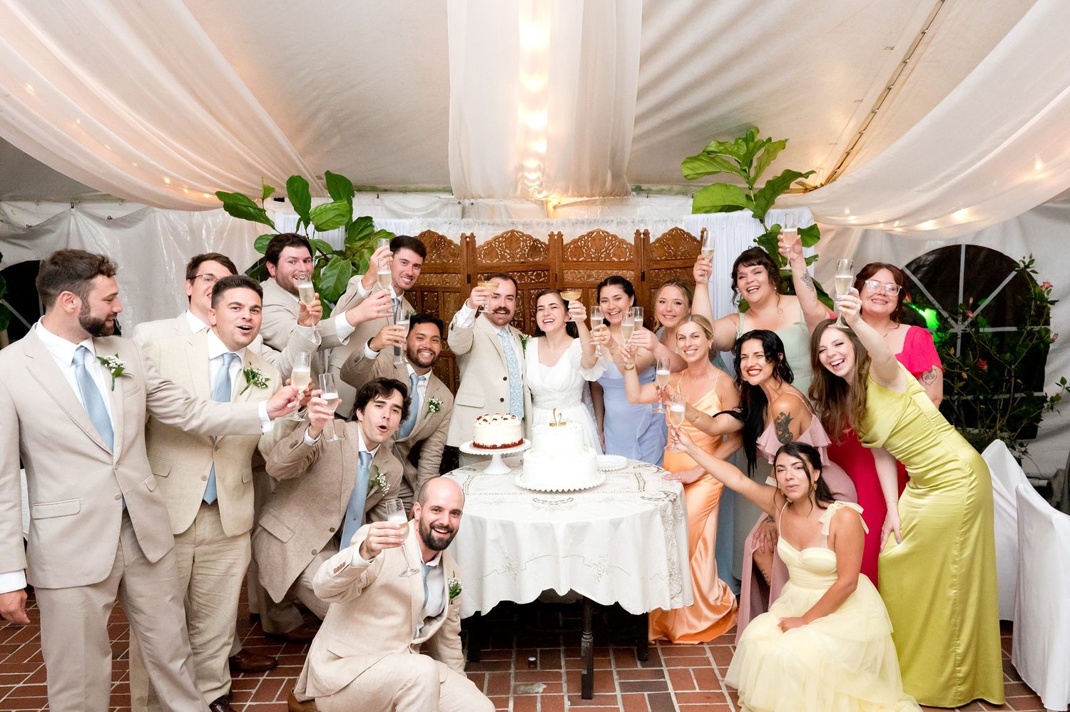 Joyful celebration scene with guests dancing and mingling at an indoor wedding reception.