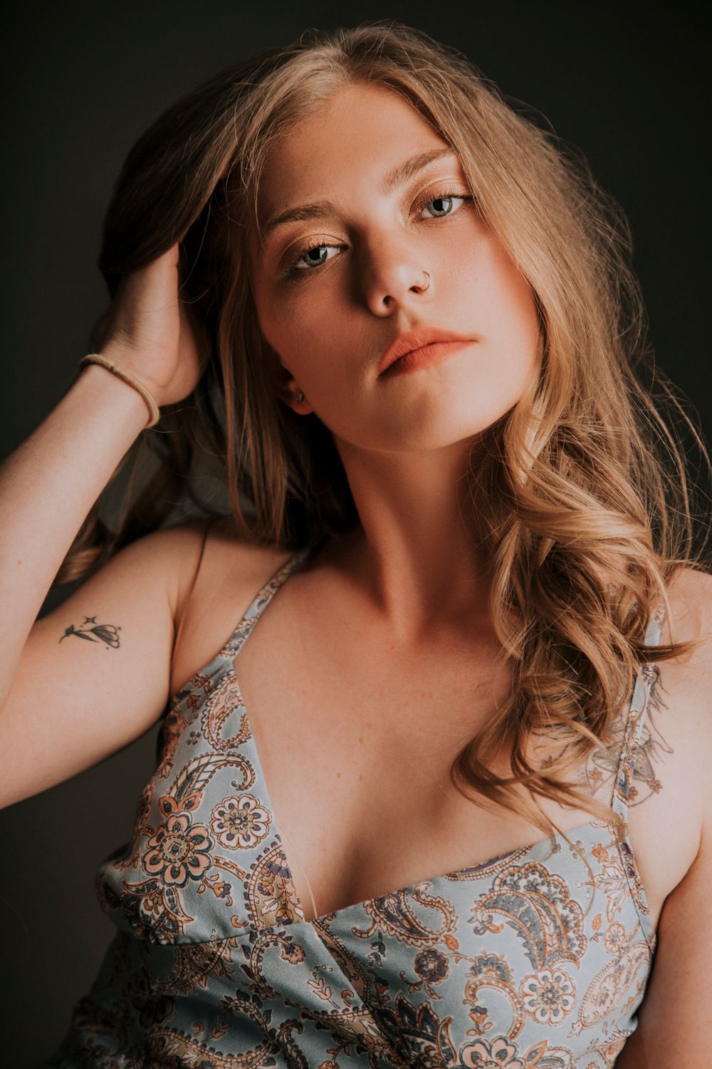 Portrait photos showing a model wearing a light blue lace lingerie set in moody dramatic lighting.
