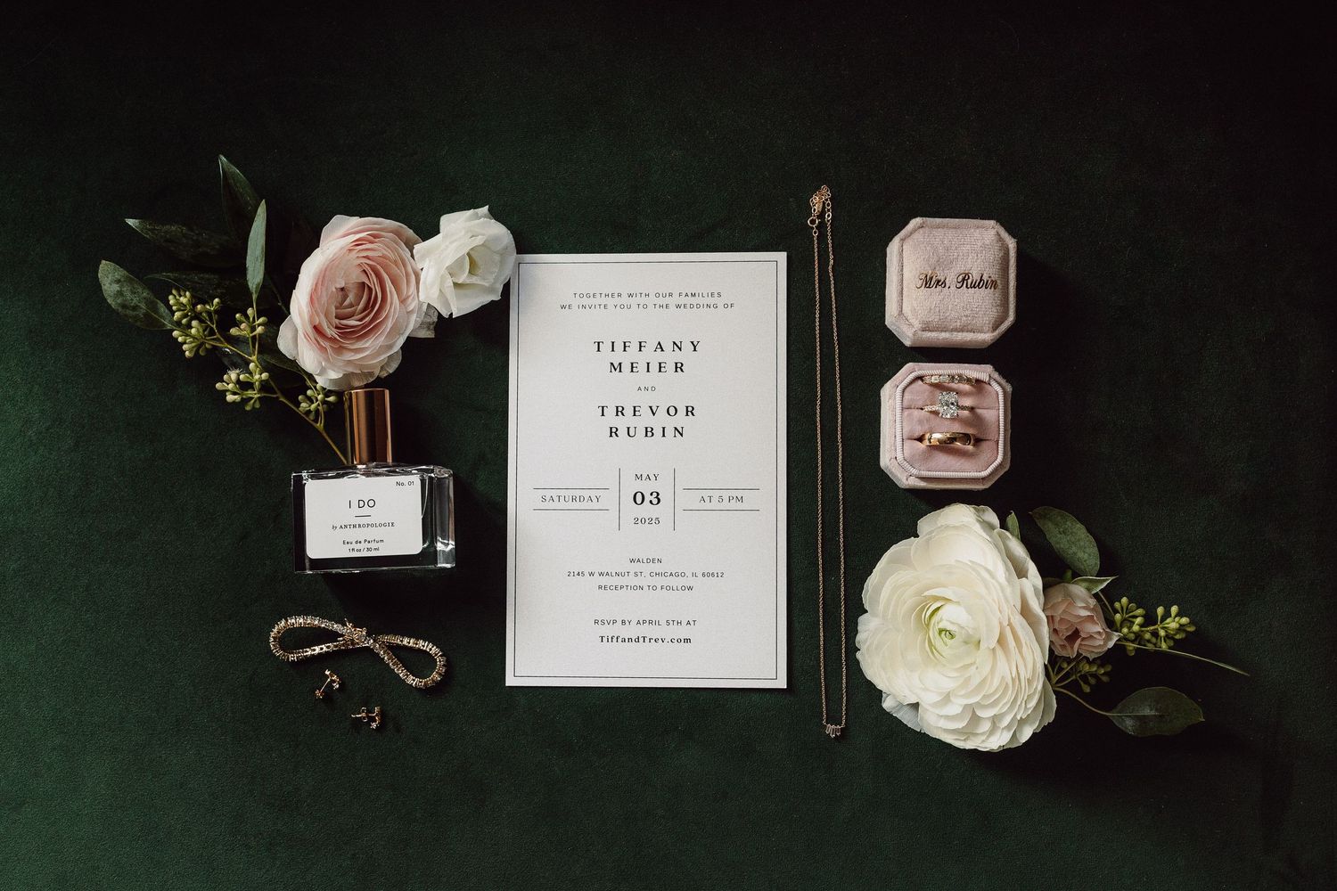 Wedding invitation suite with roses and decorative elements on dark green background.