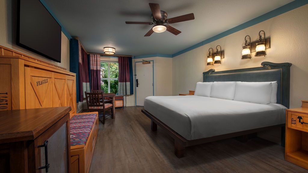 Modern hotel rooms featuring comfortable beds, ceiling fans and wooden decor.