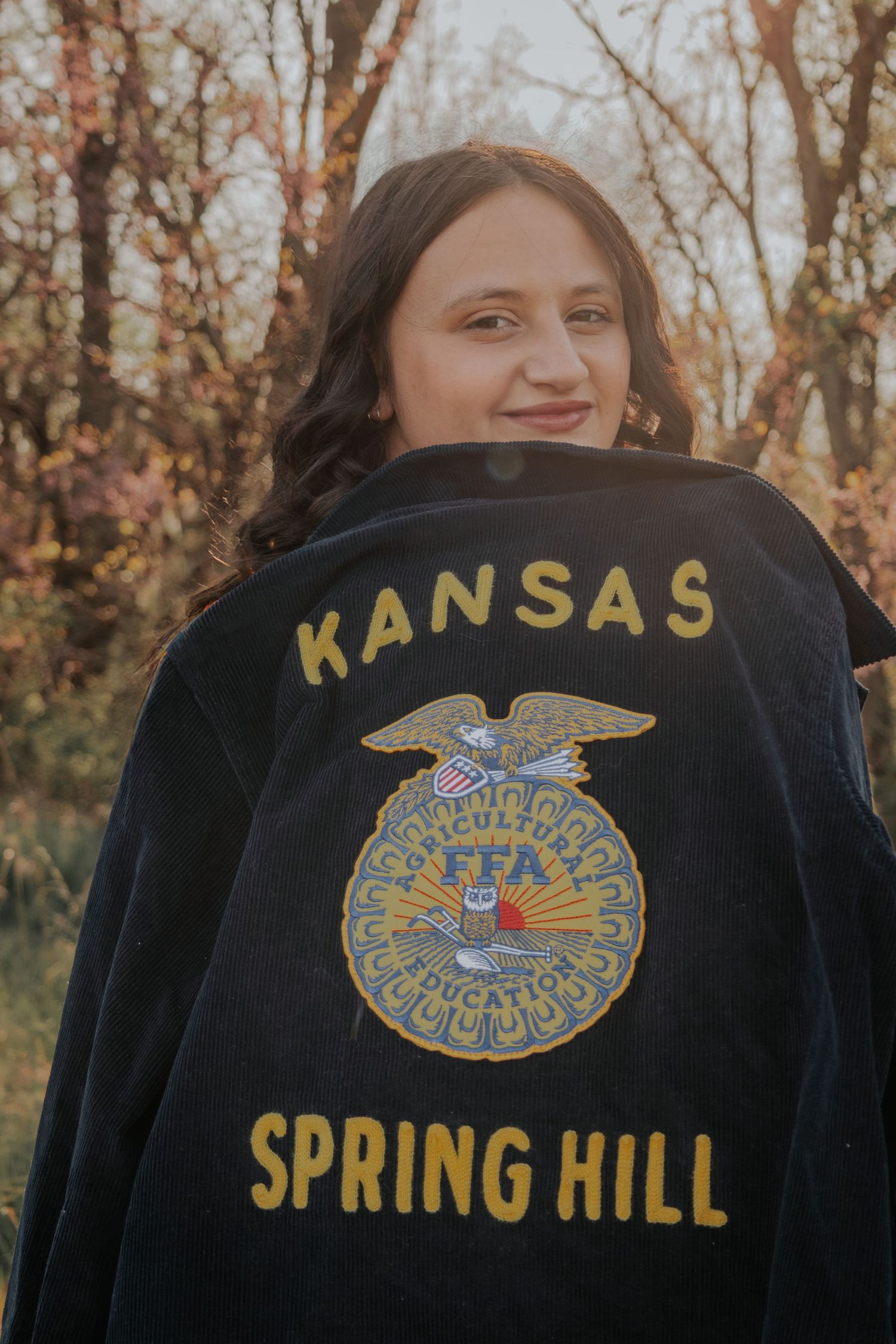 Eight close-up photos showing different angles of a black FFA jacket with embroidered logos and text reading 'Kansas Spring Hill'.