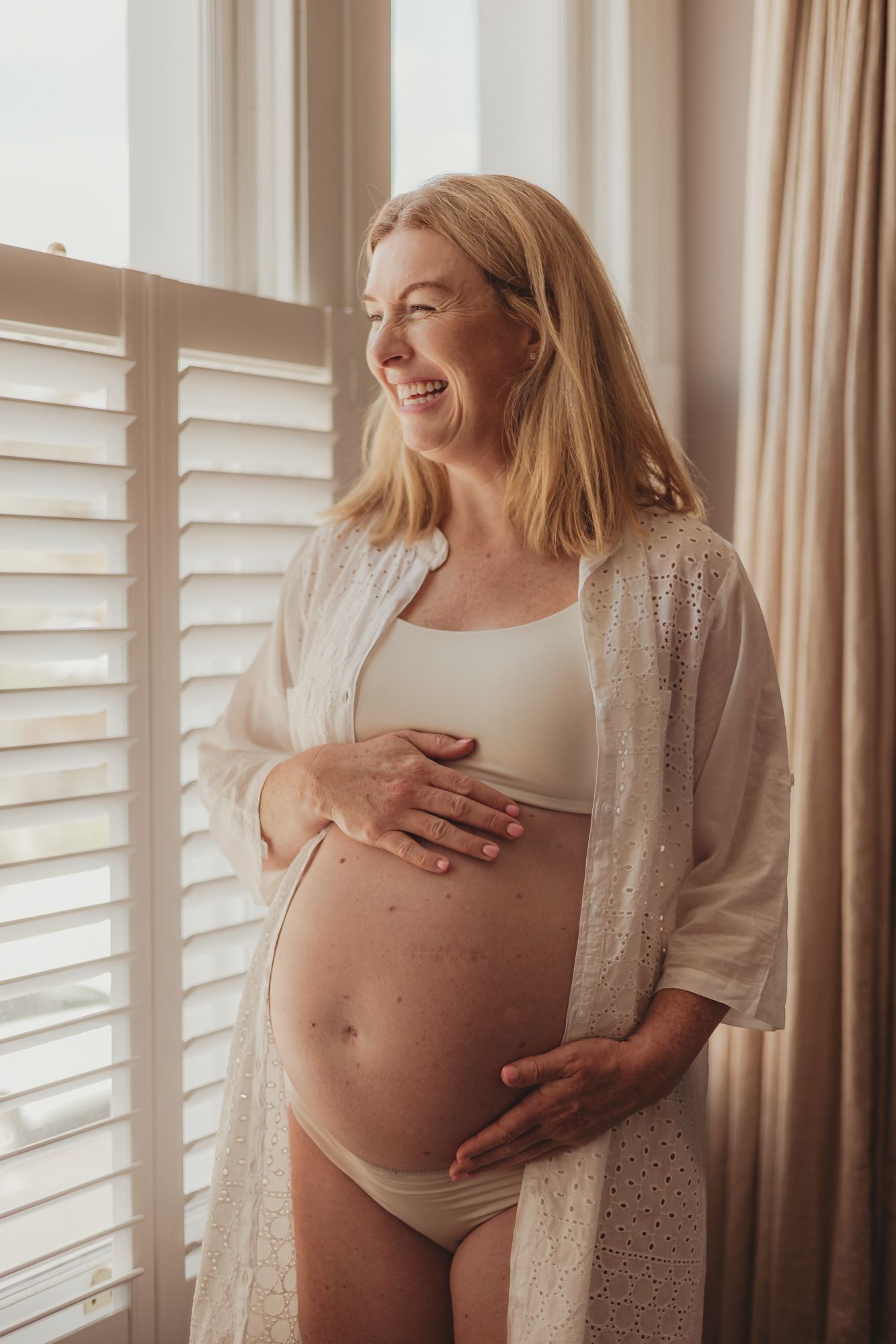pregnancy / maternity photoshoot in Balham - pregnant bump shown off with natural light from window