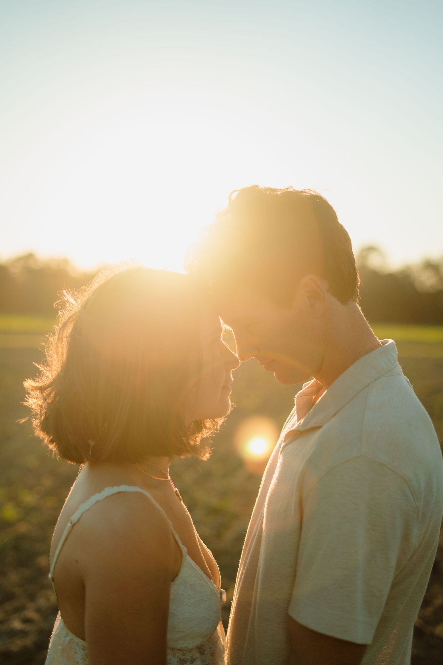 A couple dancing and embracing under white arched walkways in a romantic photoshoot sequence.
