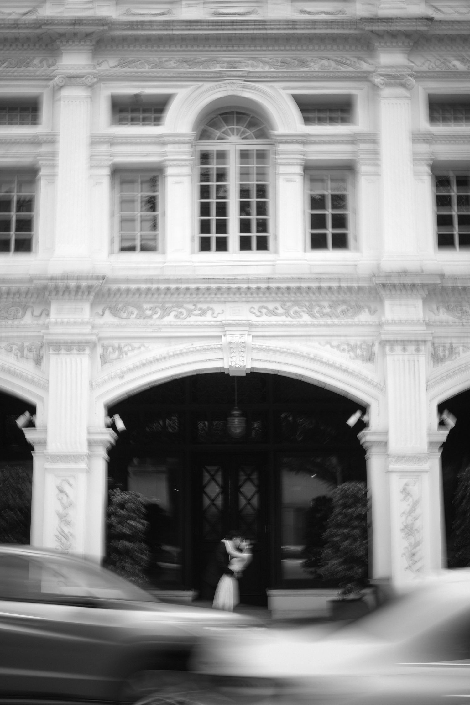 A sequence of black and white architectural photos showing a building facade with windows and arches in motion blur.