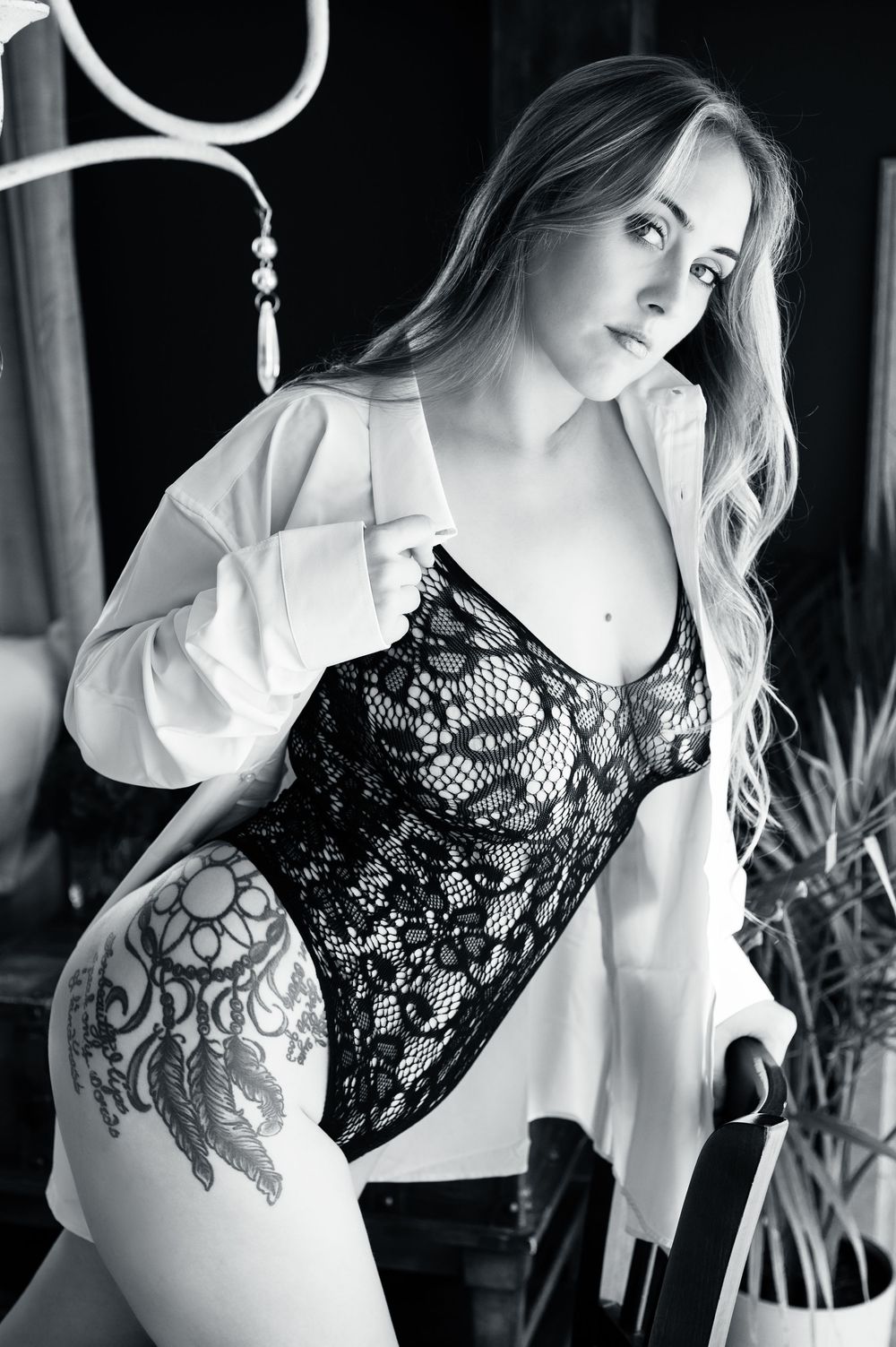 Black and white artistic portrait series featuring delicate lace details against white fabric in dramatic lighting.