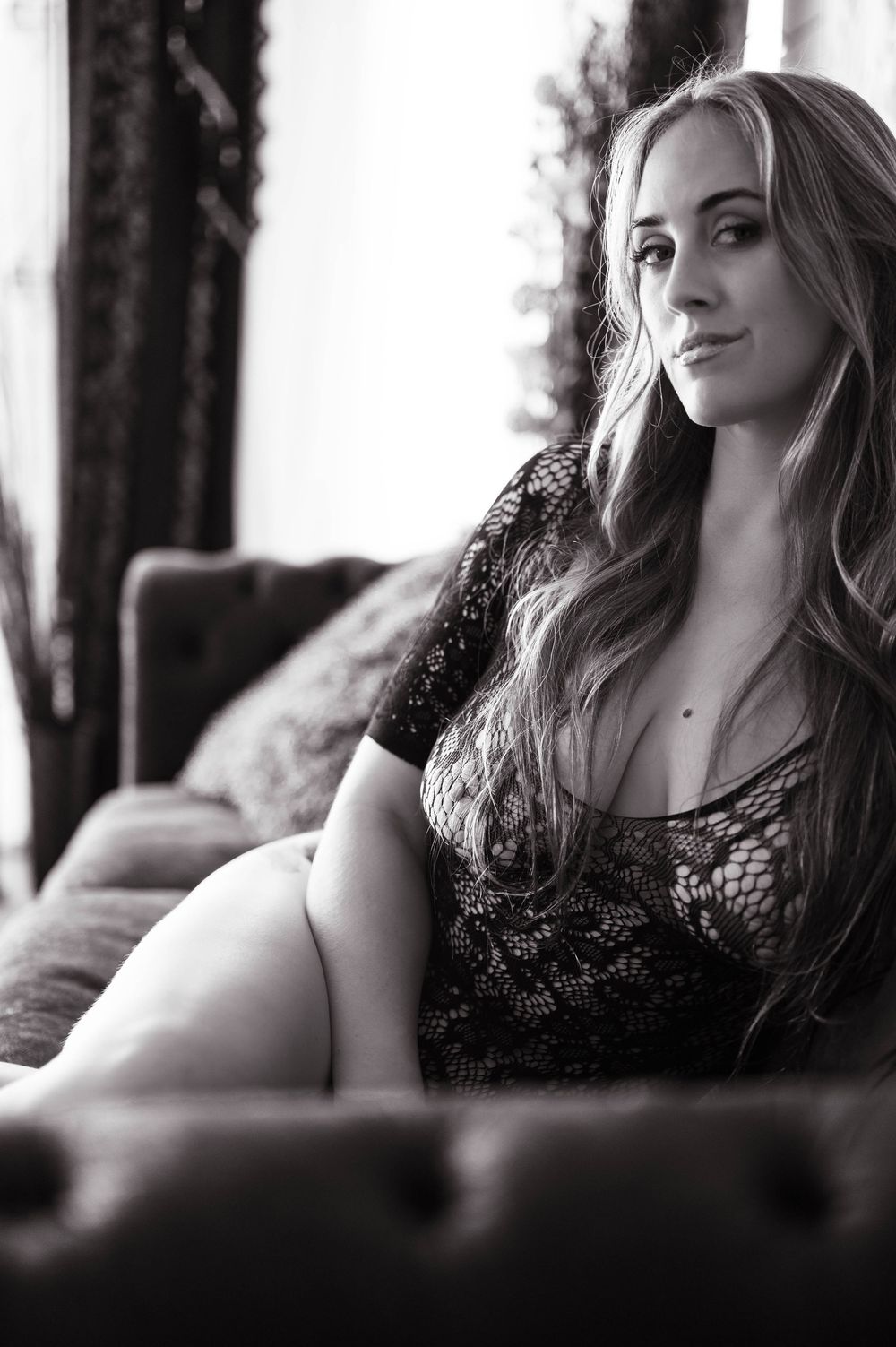 Black and white artistic portrait series showing a person in lace top reclining against dark background.
