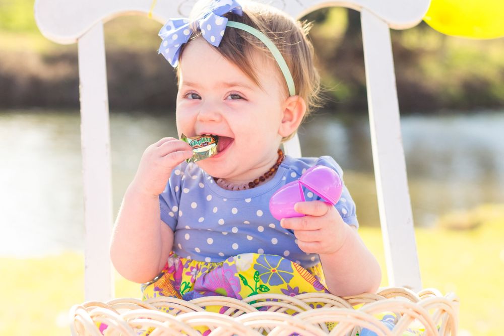 Young girl wearing a colorful dress smiles and laughs in a series of joyful outdoor portraits.
