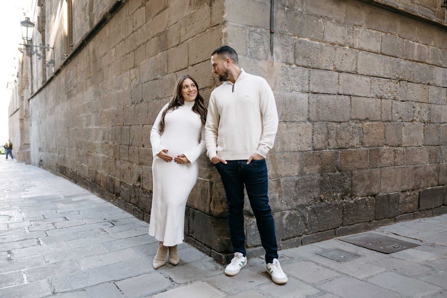 Romantic photoshoot in stone passageway with dramatic architectural elements.