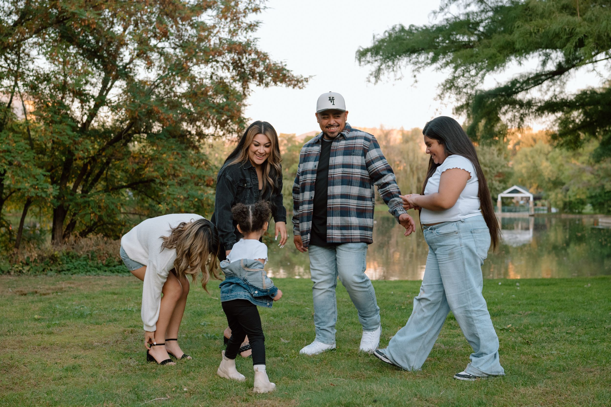 Family enjoying outdoor activities together in a park setting with multiple candid moments captured in sequence.