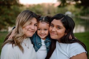 A loving family embraces and shares joyful moments together during a photo session in nature.