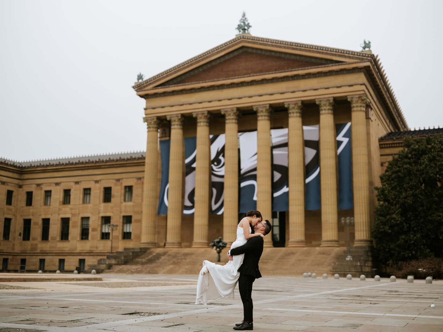 Romantic wedding portrait in front of the Philadelphia Museum of Art, with the couple sharing a moment on the iconic steps.