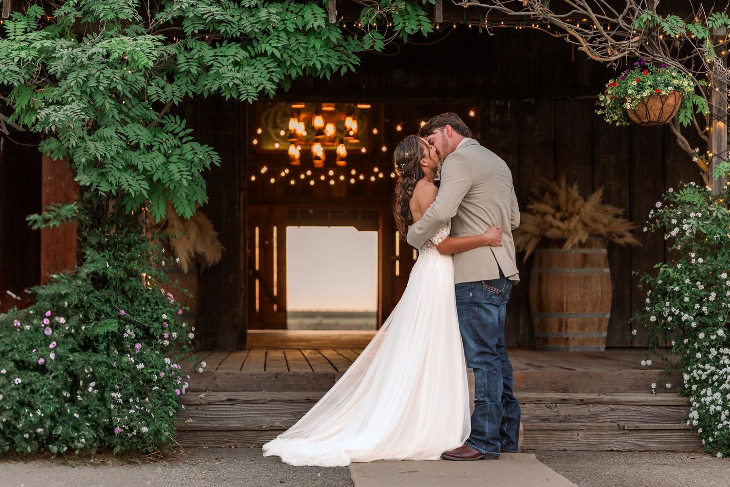 Rustic outdoor wedding venue with string lights and greenery creating a romantic garden setting.