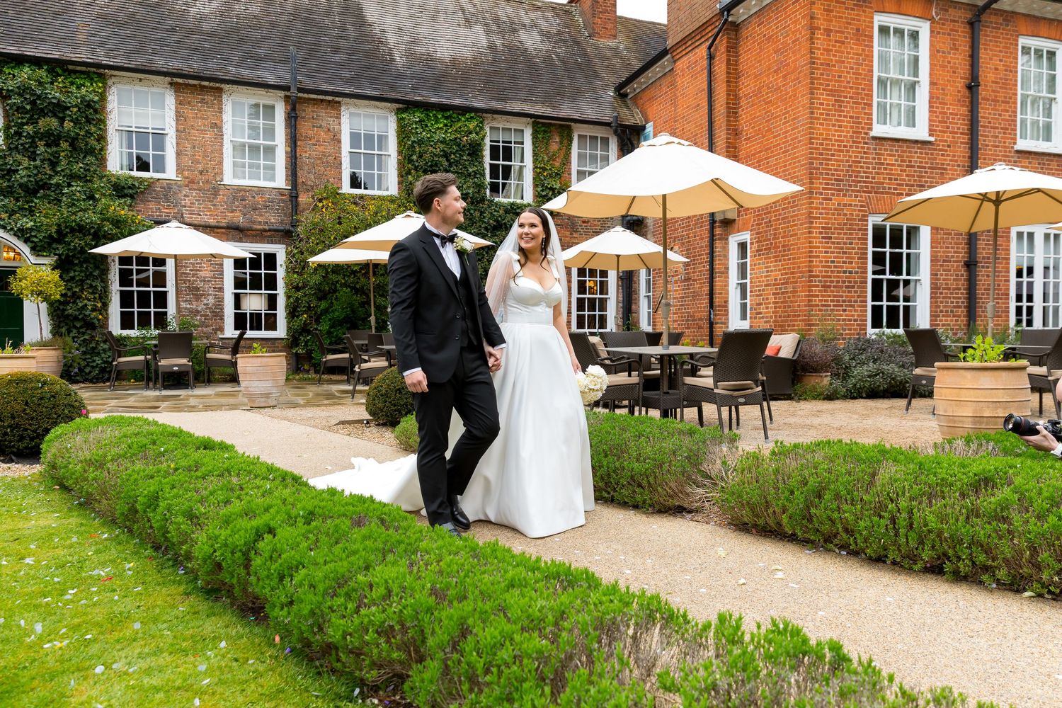 Bride and groom have a walk in the courtyard area of during their Bush Hotel Wedding Photography portraits.