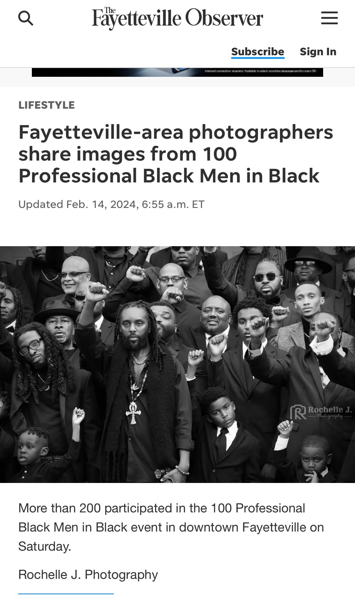 Large group of formally dressed participants gather at the 100 Professional Black Men in Black event in downtown Fayetteville.