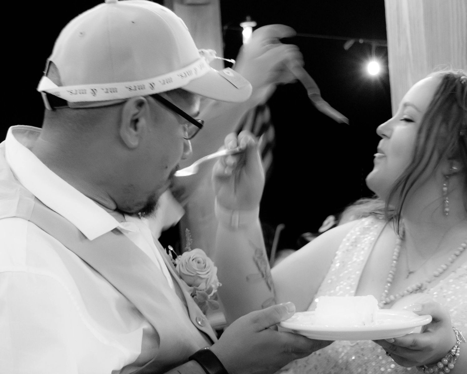 A series of black and white wedding photographs showing romantic kisses between newlyweds.