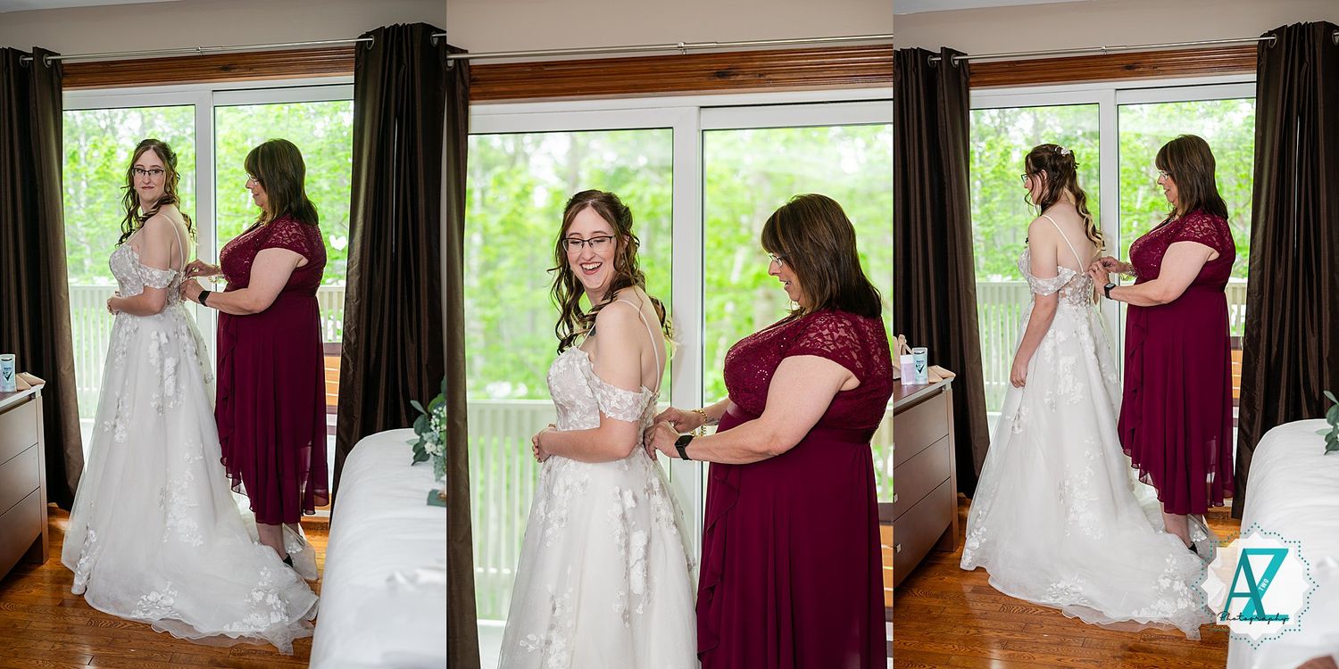 A wedding preparation scene with a white bridal gown and burgundy bridesmaid dress by large windows in natural light.