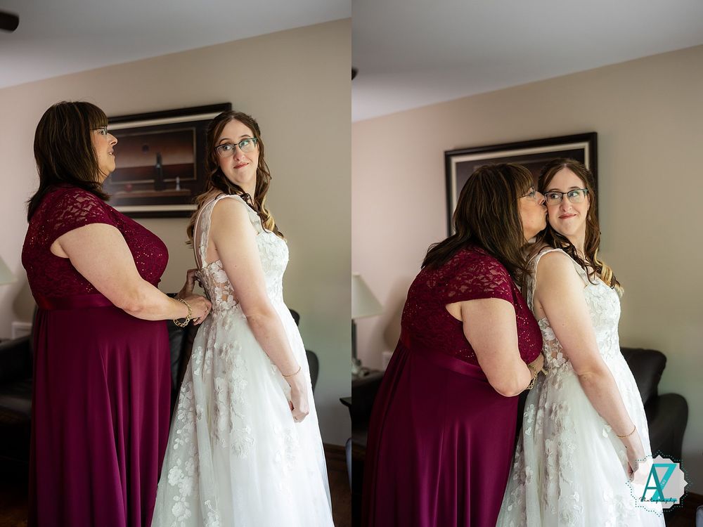 Two people in formal attire stand together, one wearing a burgundy dress and one in a white lace gown.