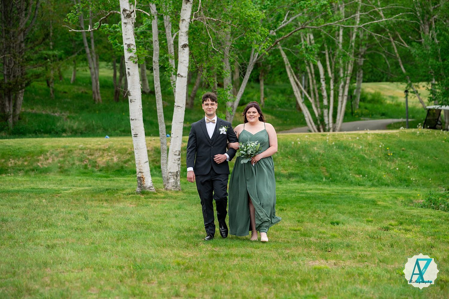A couple stands together in a scenic birch grove during a spring wedding celebration.