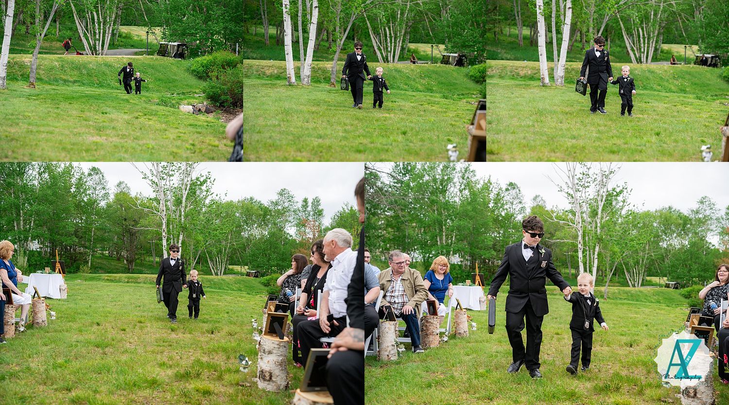 A wedding party walking through a scenic garden path with white birch trees and green grass.