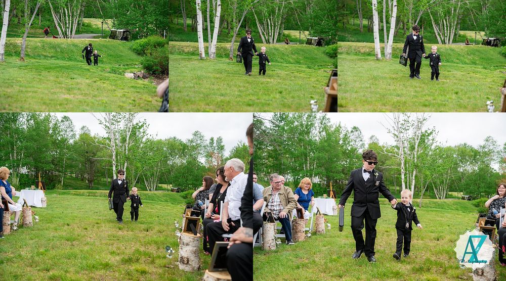 A wedding party walking through a scenic garden path with white birch trees and green grass.