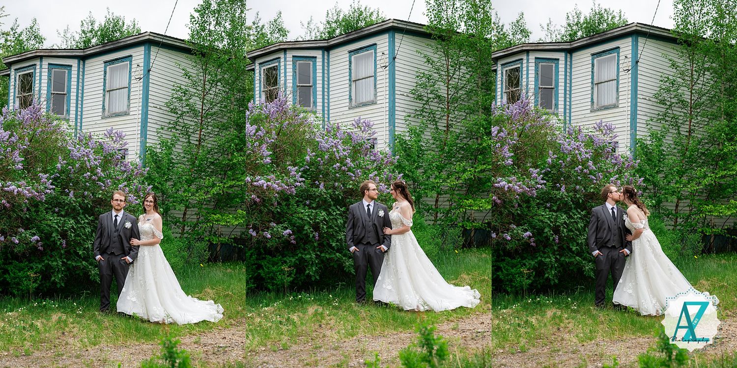 Couple poses together by blooming lilac bushes against rustic teal-colored building in three sequential photos.