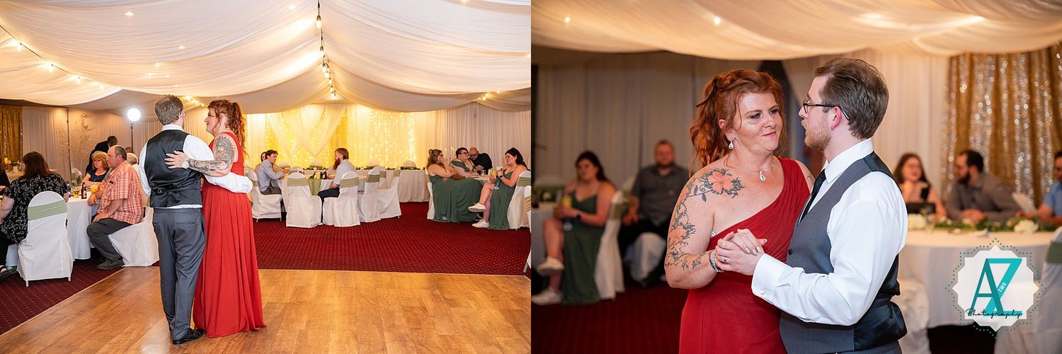 Couples dance together in an indoor reception venue with draped ceiling decorations and soft lighting.