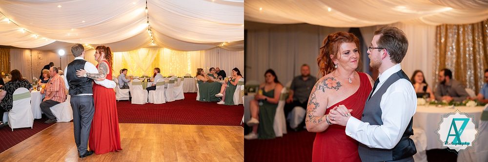 Couples dance together in an indoor reception venue with draped ceiling decorations and soft lighting.