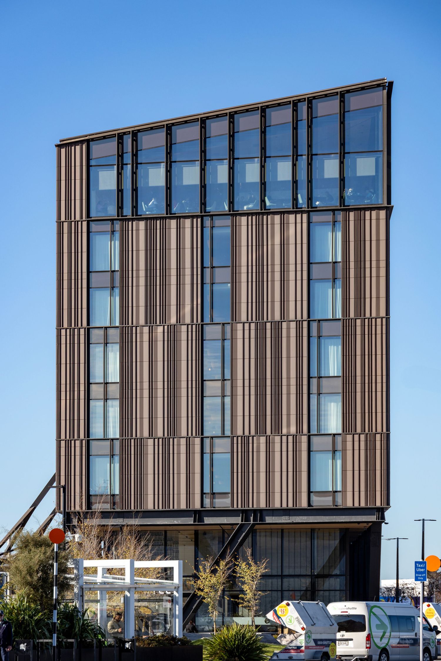Tall wooden office building with modern design and glass windows.
