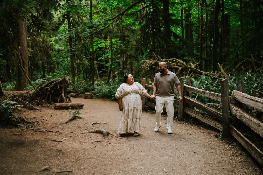 Photography of engaged couple walking through forest in Cathedral Groves, MacMillan Park. Vancouver Island adventure photographer