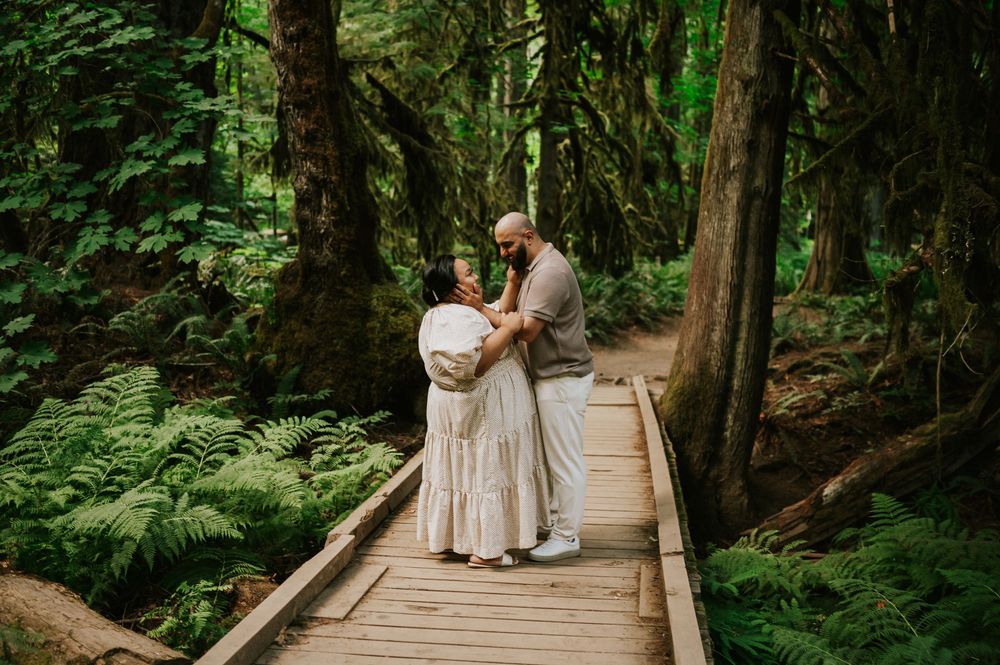 Romantic portrait of engaged couple embracing in Cathedral Groves, MacMillan Park forest trails. Vancouver Island adventure photographer