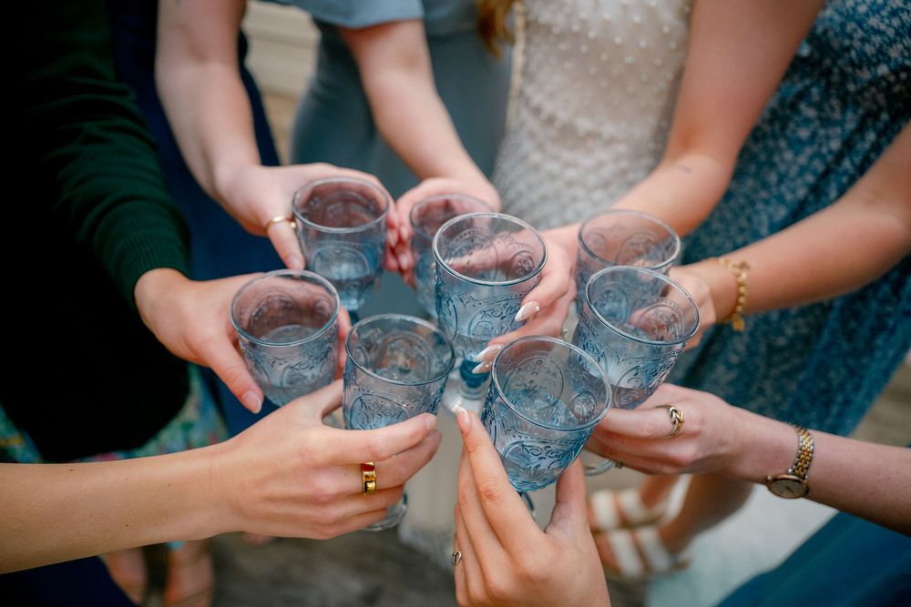 Close-up of bridal party clinking glasses during a bridal shower celebration in Dallas–Fort Worth