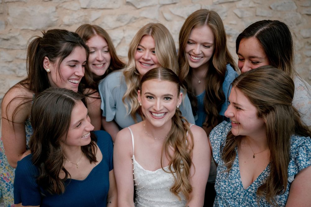 Bride surrounded by bridesmaids laughing together at a Dallas–Fort Worth wedding shower