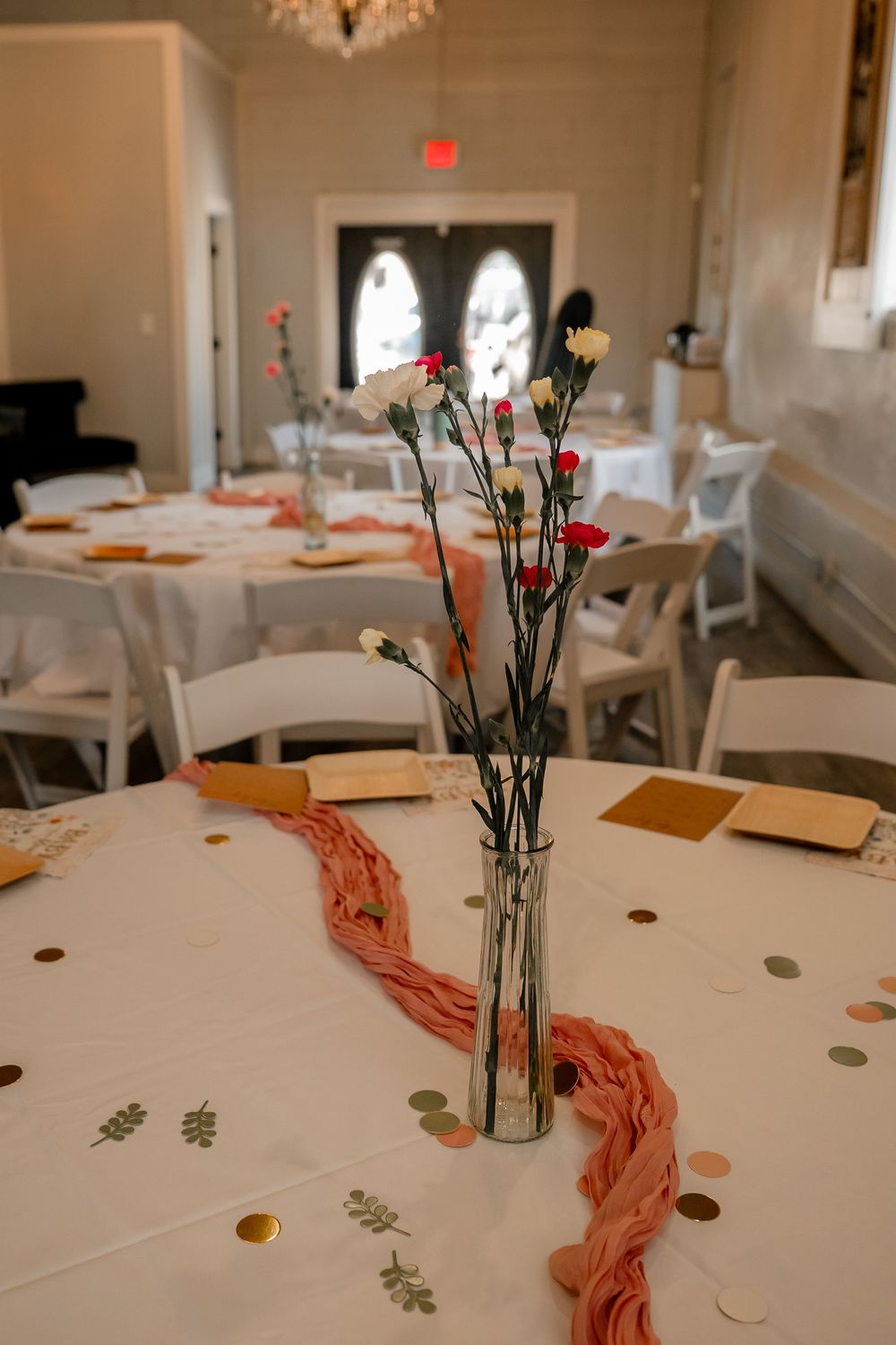 Detail shot of baby shower table arrangement with roses and pink details at a DFW celebration
