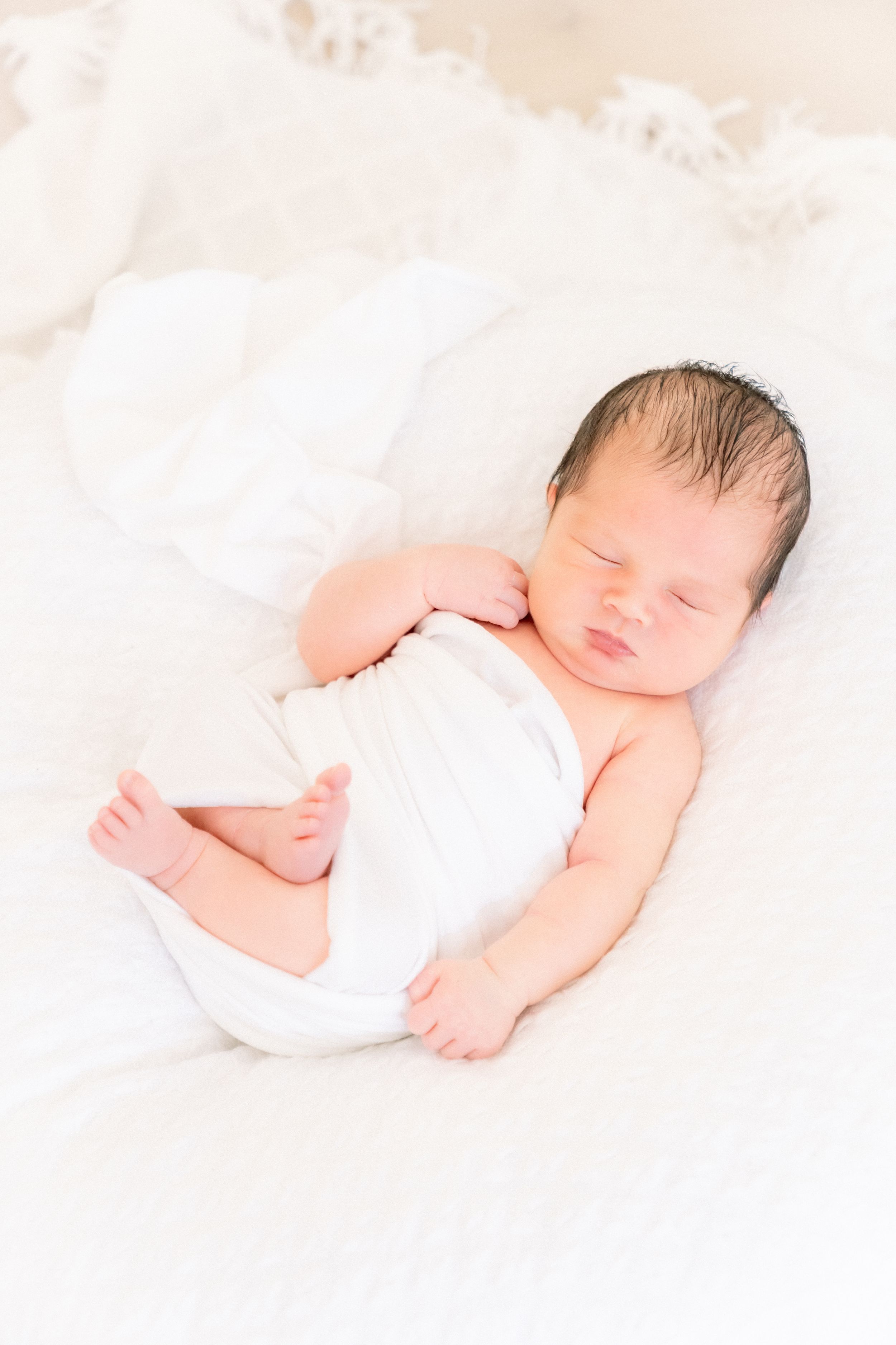 sleeping cozy baby during his newborn photoshoot in largo florida
