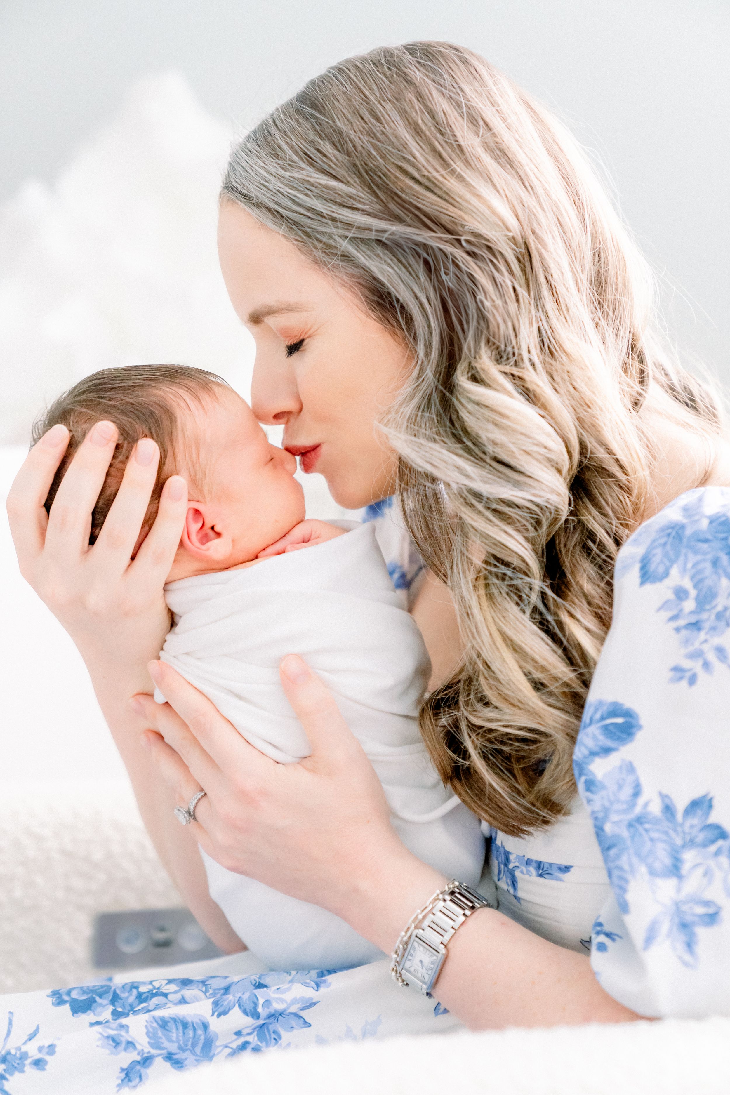 mother kissing her baby girl on the nose during her newborn photography session in Tampa florida