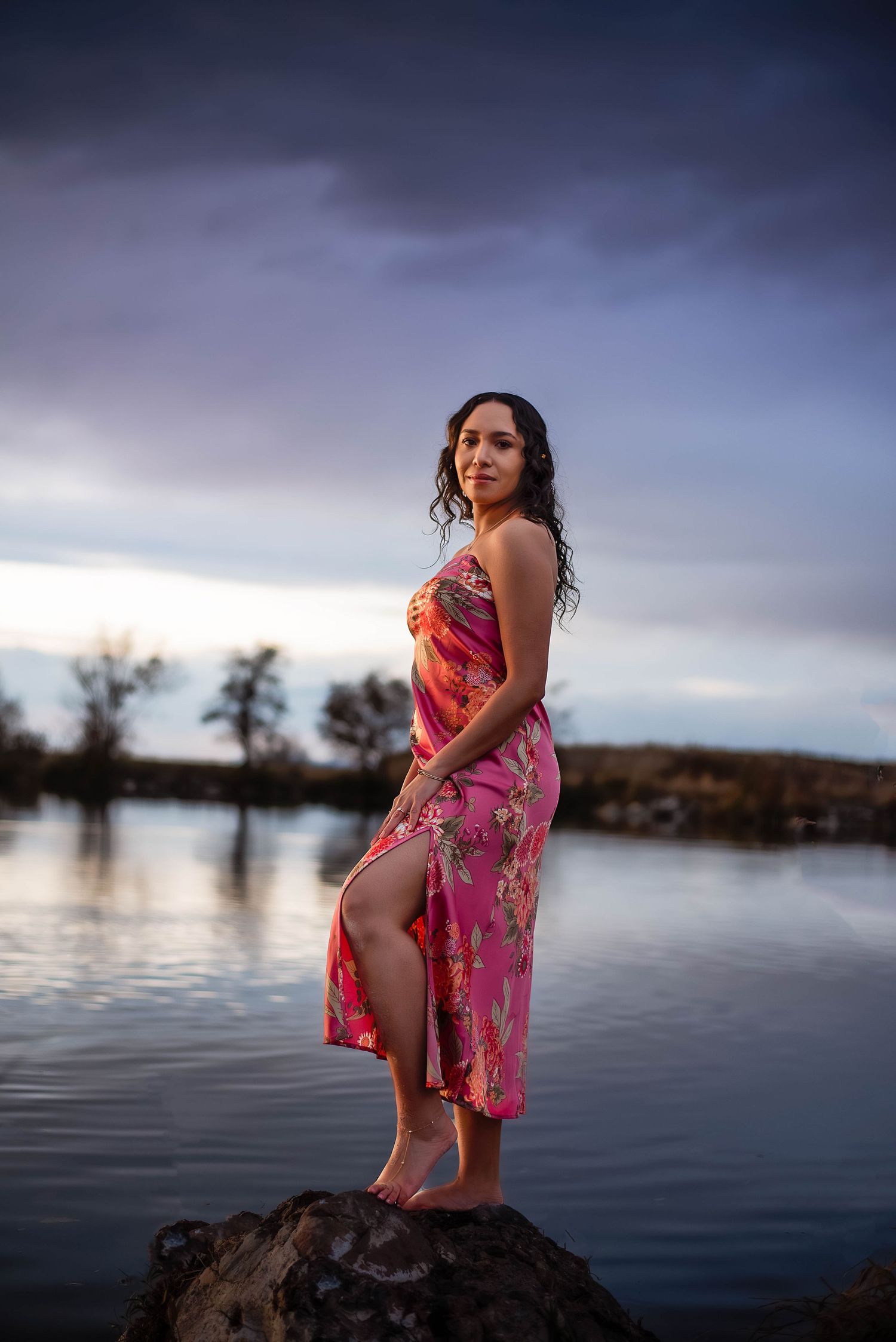 empowering woman standing in front of water during blue hour of the evening at Bountiful Pond, Utah