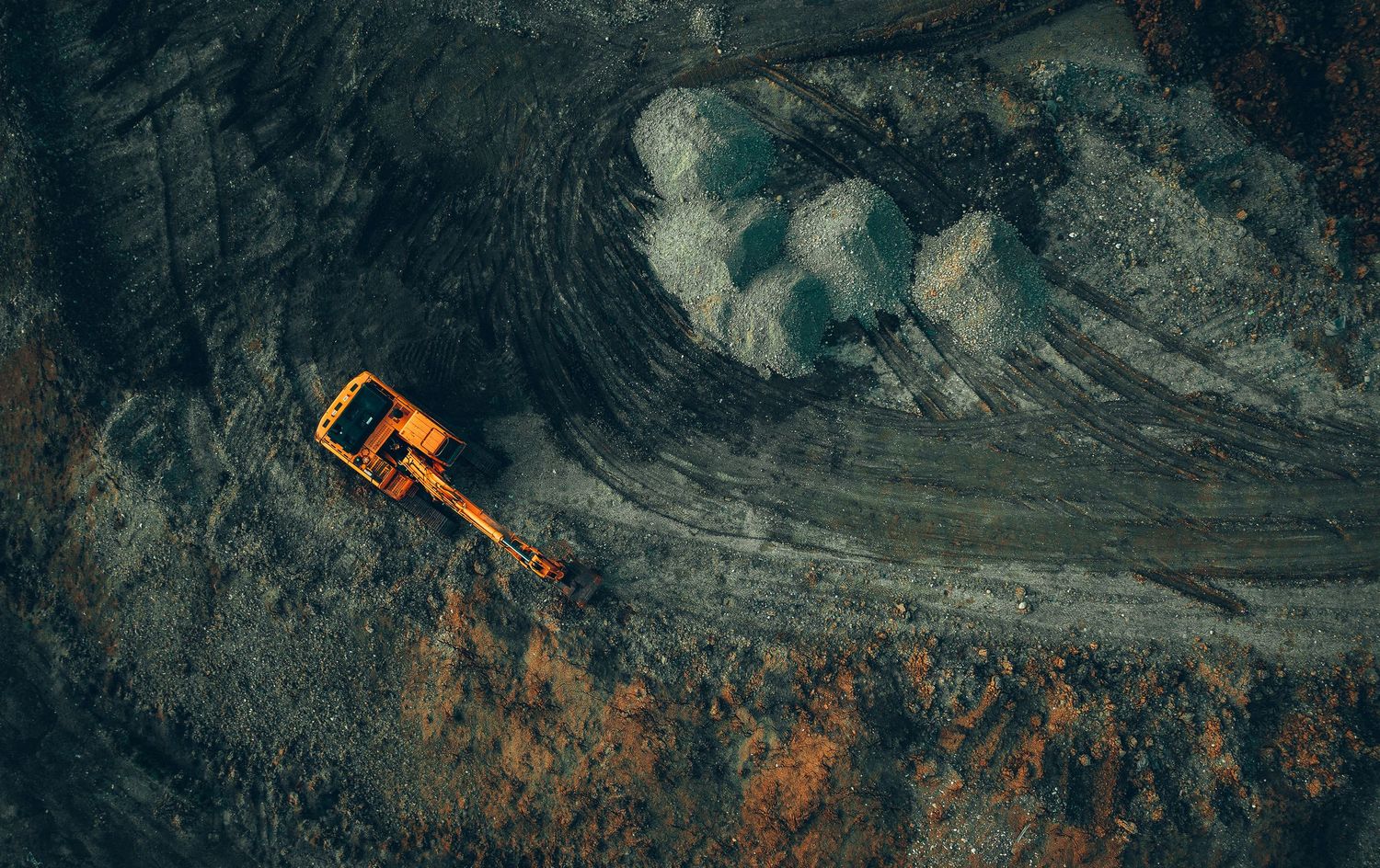 Aerial Site Intelligence view of heavy machinery working in a quarry or mining site.