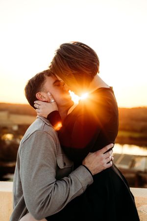 Silhouetted couple sharing an intimate moment during golden hour in Branford, CT.