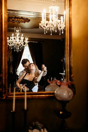 Couple dancing under elegant crystal chandeliers in a luxurious room Branford, CT.