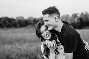 Black and white portrait of laughing couple in casual outdoor setting in Branford, CT.