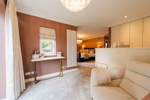 Contemporary living space with terracotta walls, cream furniture, and elegant dressing table. Interior design photography in Surrey.