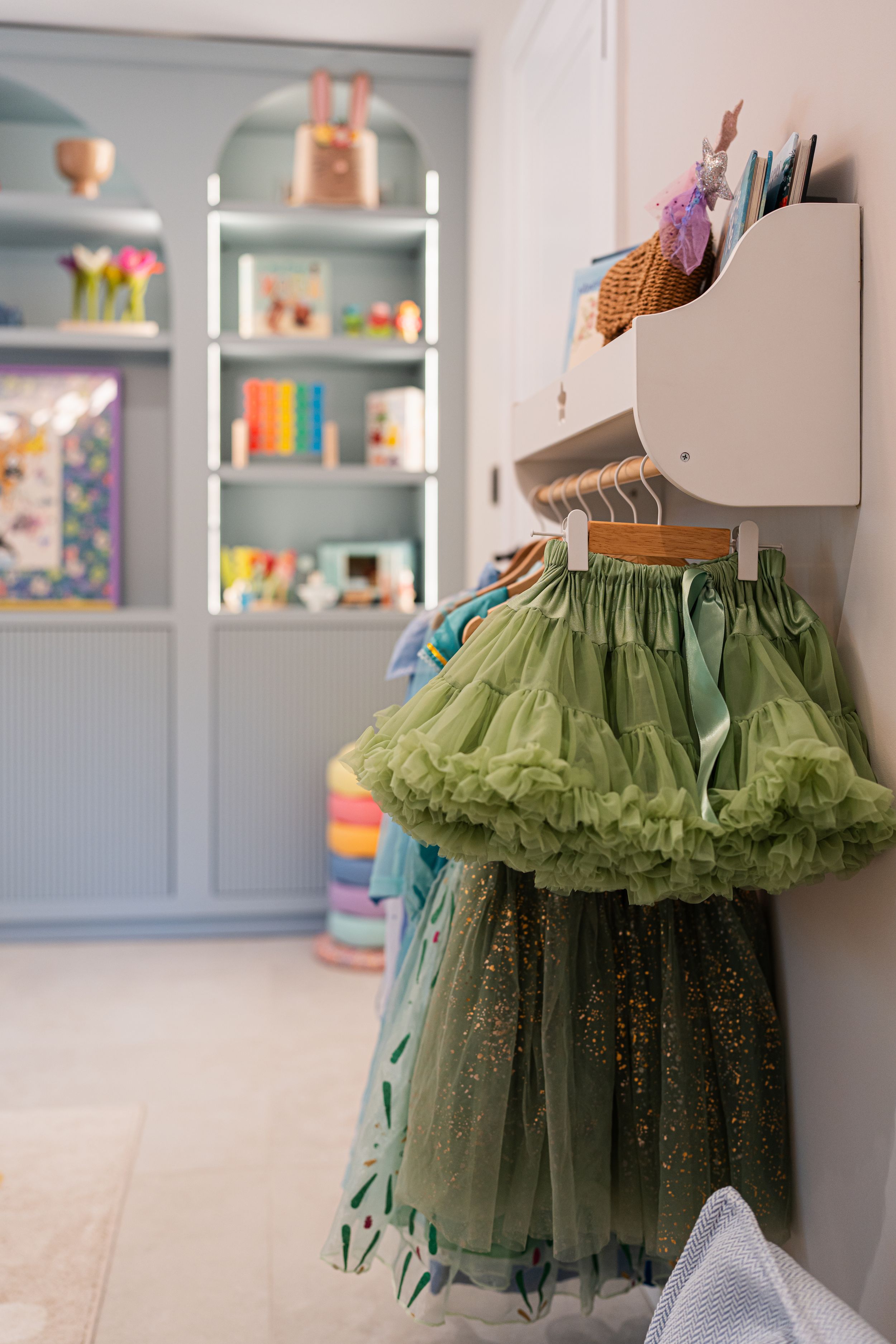 Green tulle tutu skirt with ruffles displayed on a dress form mannequin against a white background.