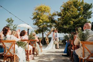 A collage of outdoor wedding ceremony moments with string lights and trees in the background.
