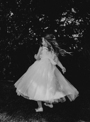 A series of black and white photos showing a white dress twirling in motion against a dark background.