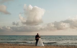A collection of beach wedding photos showing romantic silhouettes against a sunset sky and ocean backdrop.