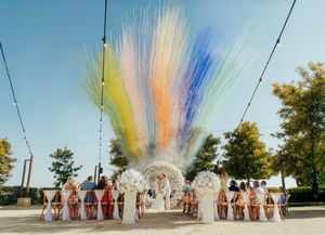 Colorful powder explosion sequence captured in outdoor setting with group of people standing in bright sunlight.