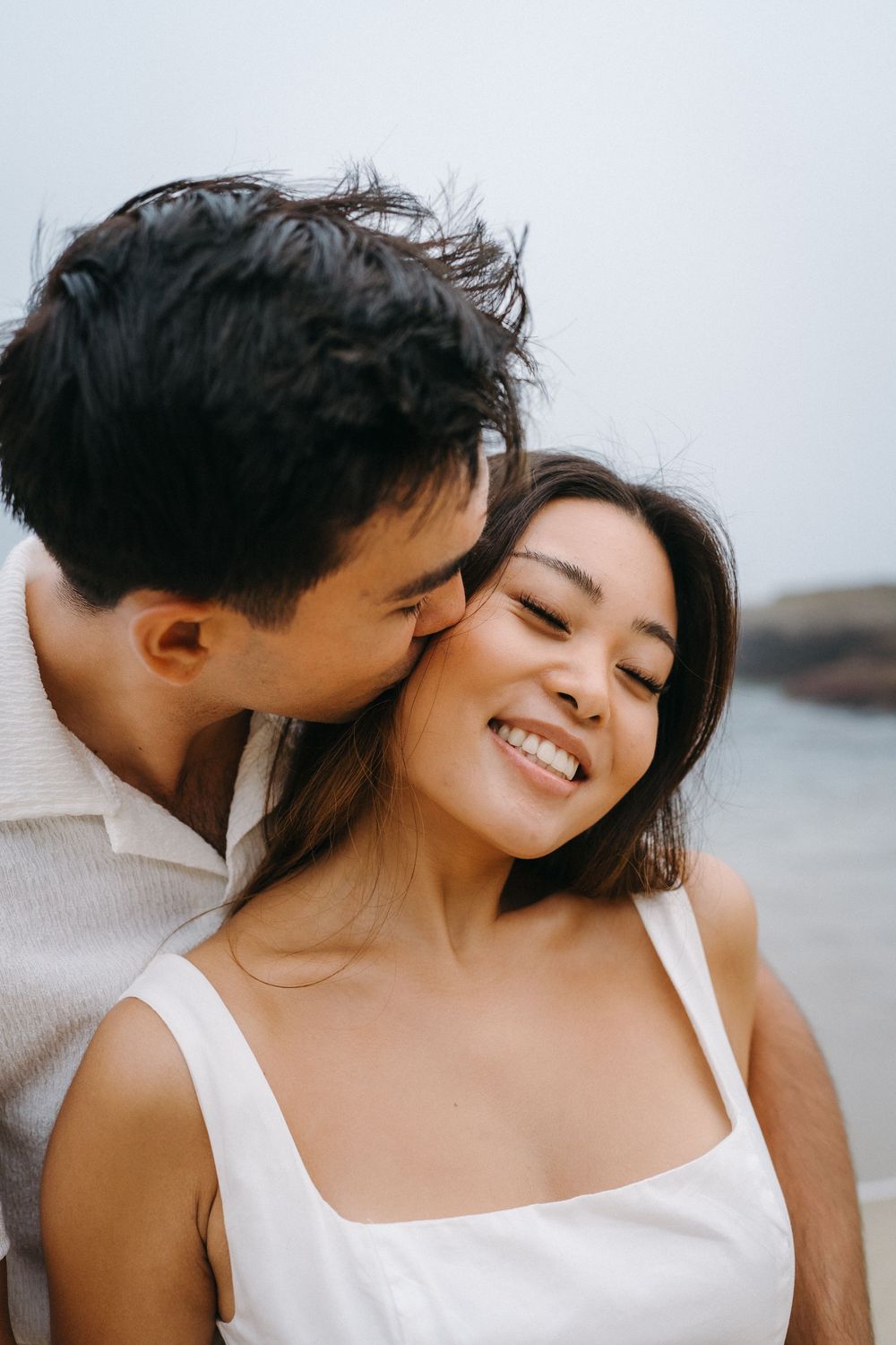 A romantic couple embraces on a beach, sharing intimate moments in a series of three candid photos.
