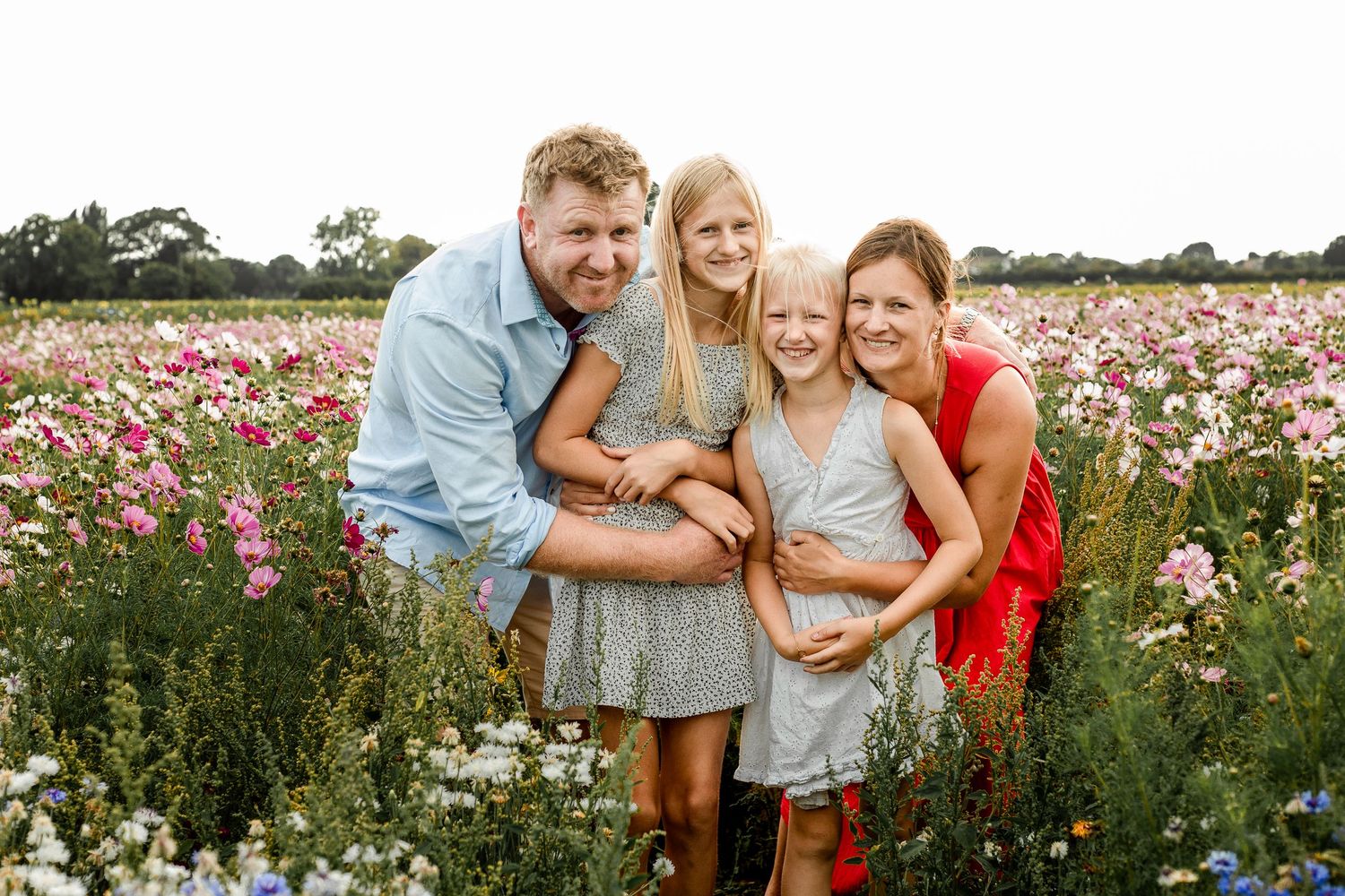 At Sam's Sunflowers on Hayling Island, Hampshire, a family laugh and play in the flowers.